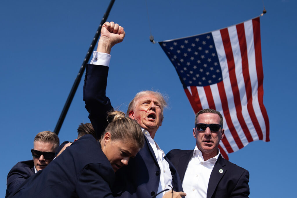 Donald Trump fait un geste après avoir été touché par balle à l'oreille droite après que des coups de feu ont éclaté lors d'un rassemblement à Butler, en Pennsylvanie, le 13 juillet.